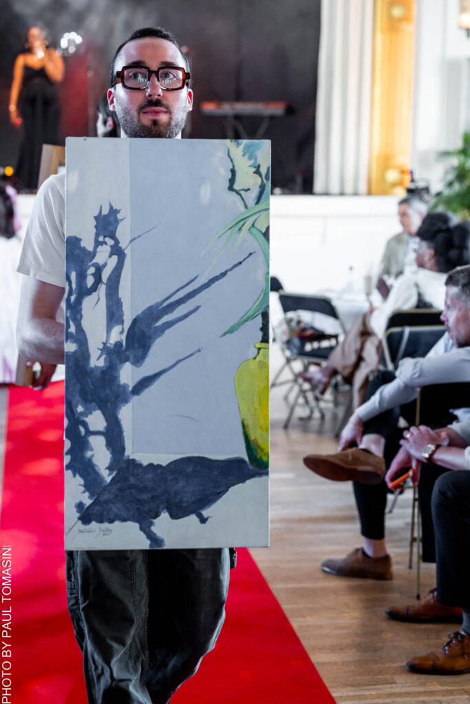 Le podium se faisait tableau vivant, chaque silhouette une touche de couleur sur la toile mouvante du défilé.